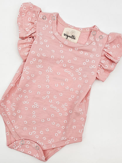 Petal Pink Baby Onesie with white daisies and short flutter sleeves