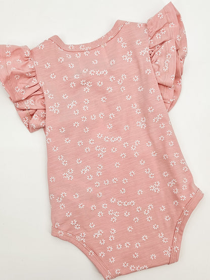 Back of Petal Pink Baby Onesie with white daisies and short flutter sleeves